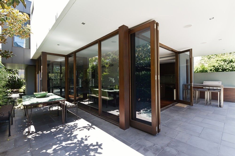 A Patio With A Table And Chairs Outside Of A House — Northern Glazing Glass & Aluminium In Smithfield, QLD