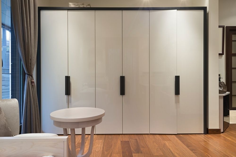 A Living Room With A Large White Wardrobe And A Small Table — Northern Glazing Glass & Aluminium In Smithfield, QLD