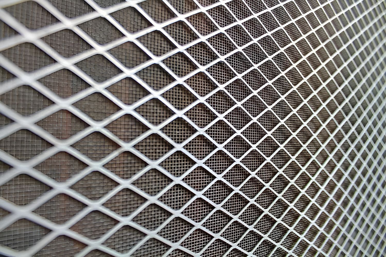 Close-Up Of A Diamond-Patterned Security Screen