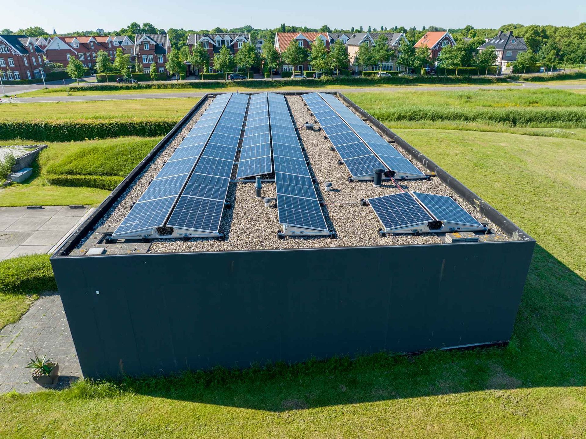 Een rij zonnepanelen op het dak van een gebouw.