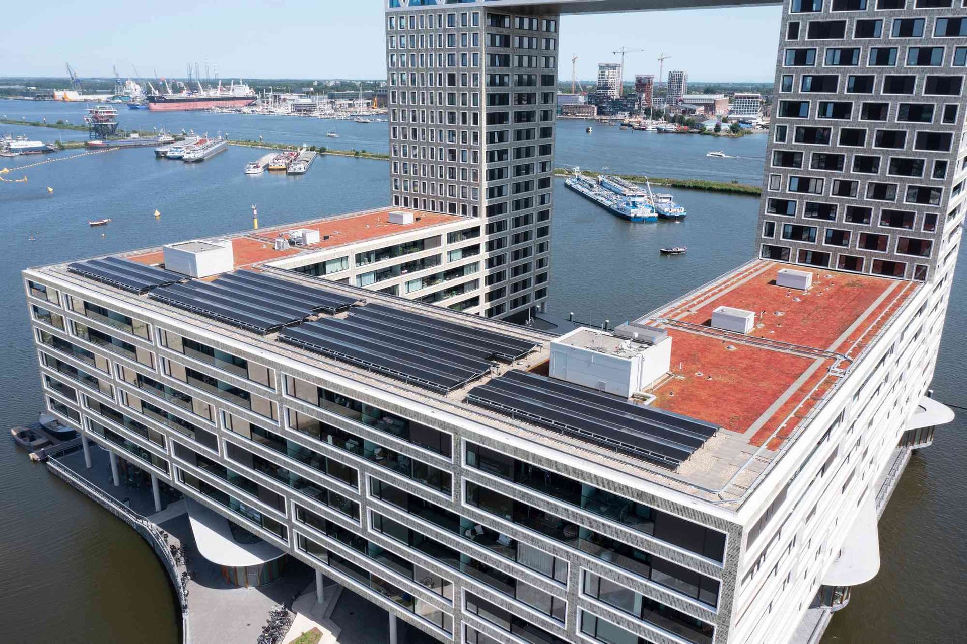 Een luchtfoto van een groot gebouw met zonnepanelen op het dak.
