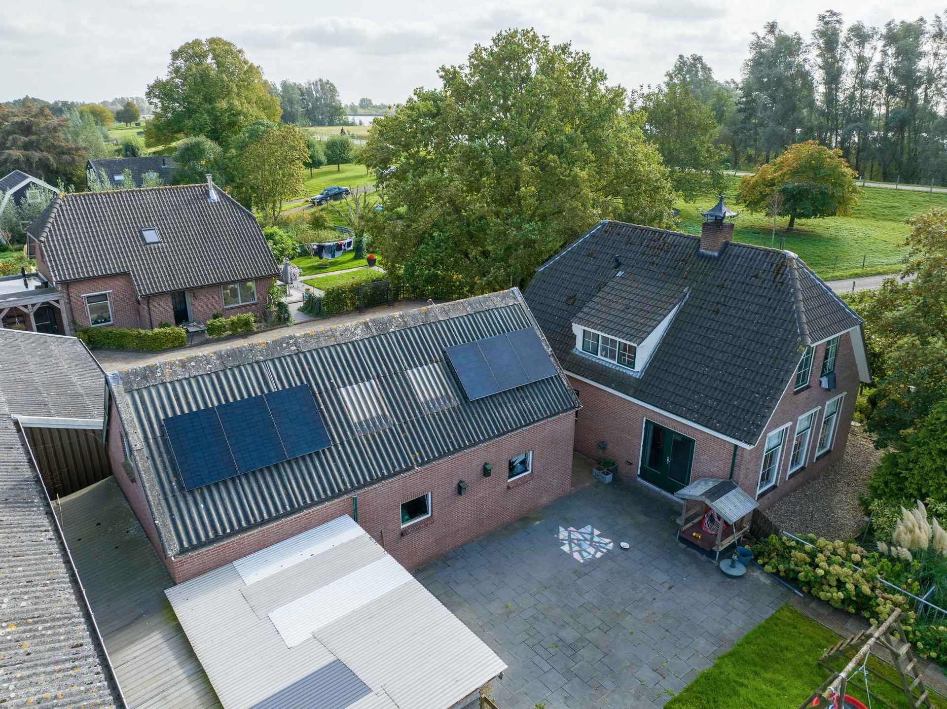Een luchtfoto van een huis met zonnepanelen op het dak.