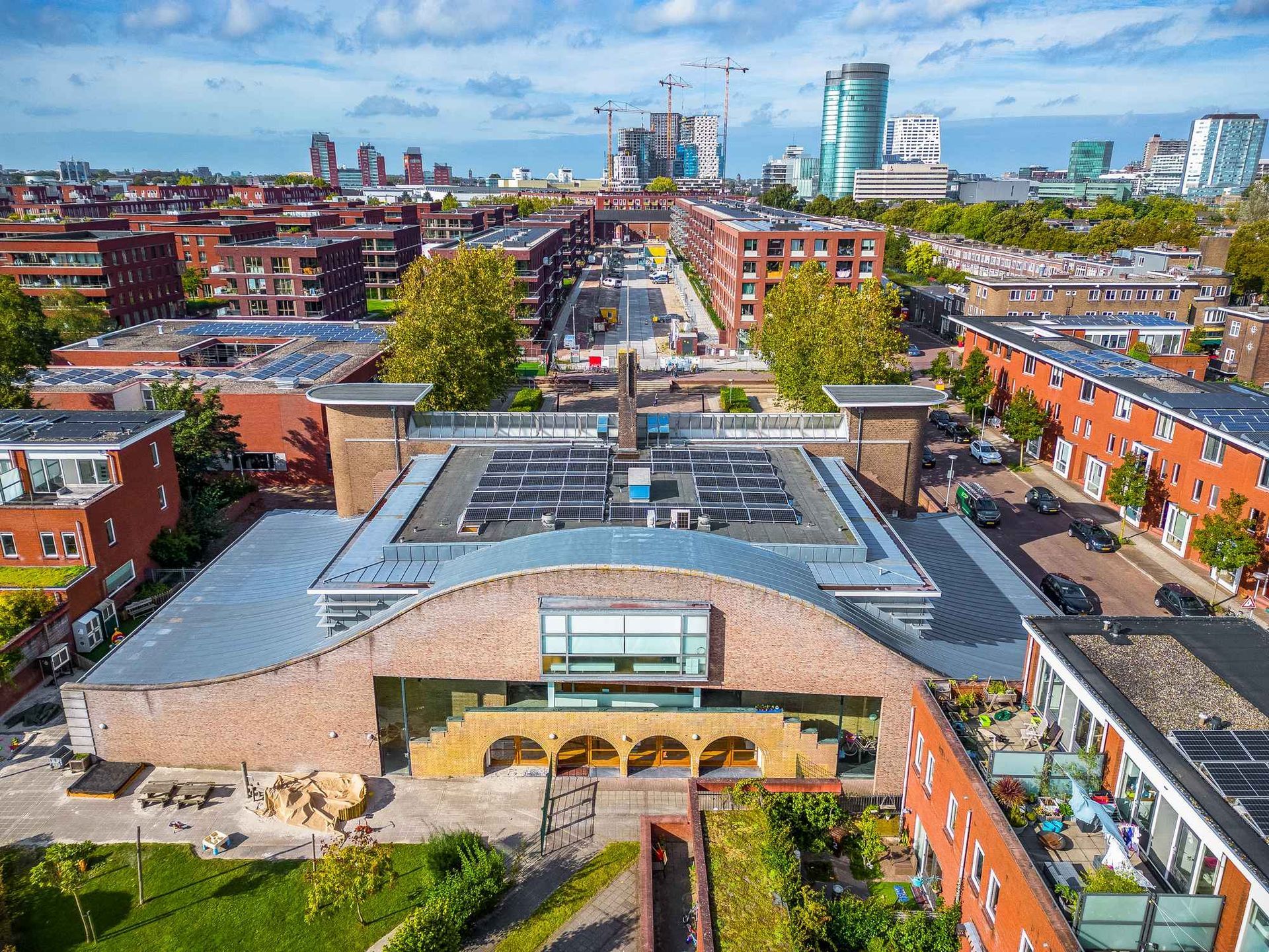 Een luchtfoto van een stad met een groot gebouw op de voorgrond.