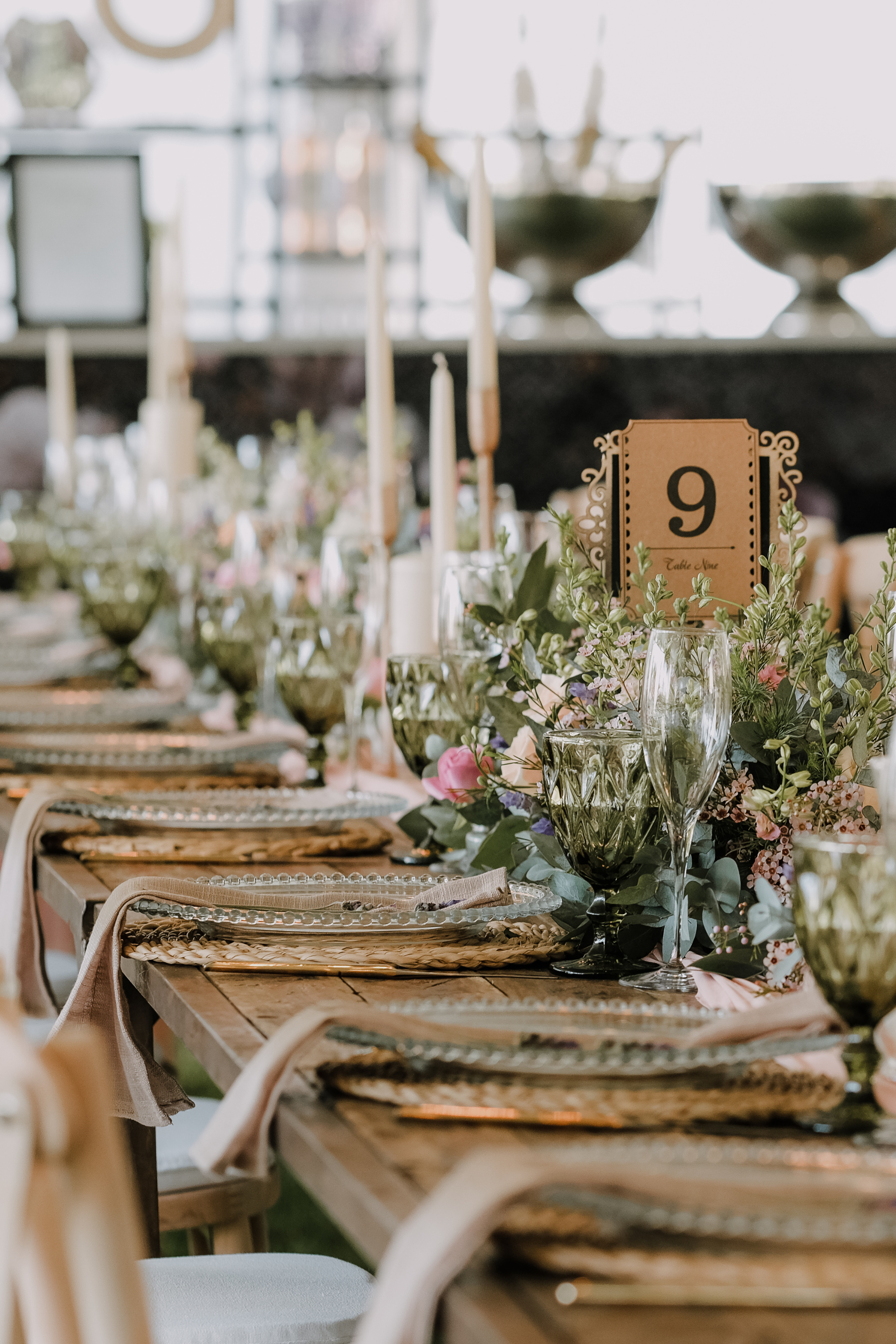 Rustic wedding reception table with elegant floral centerpieces at The R.F. Strickland Co. venue in Concord, GA.