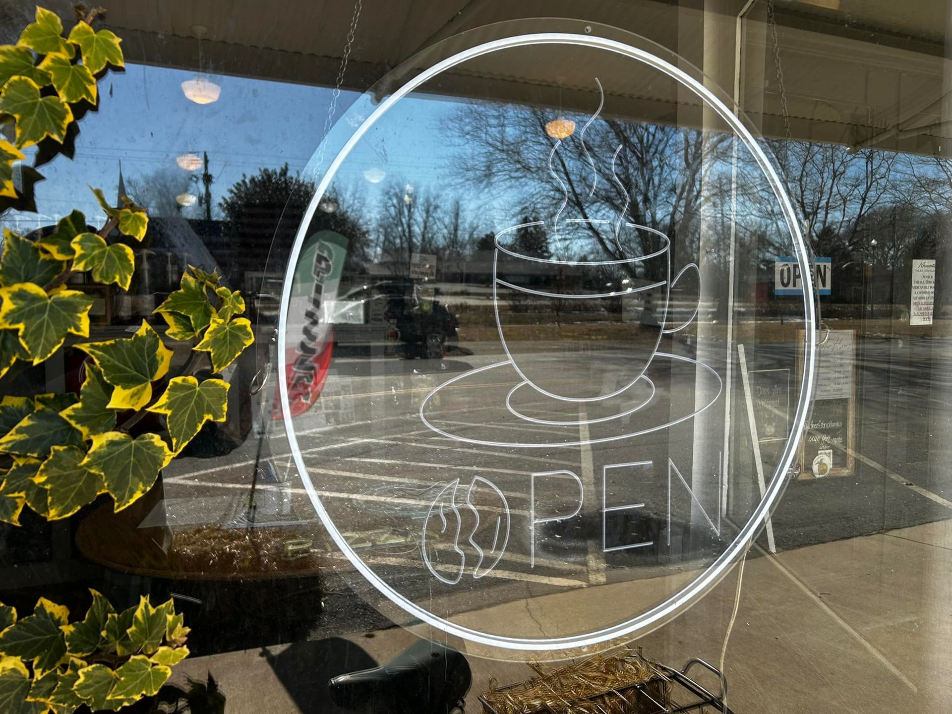 A glass window with a drawing of a cup of coffee on it.