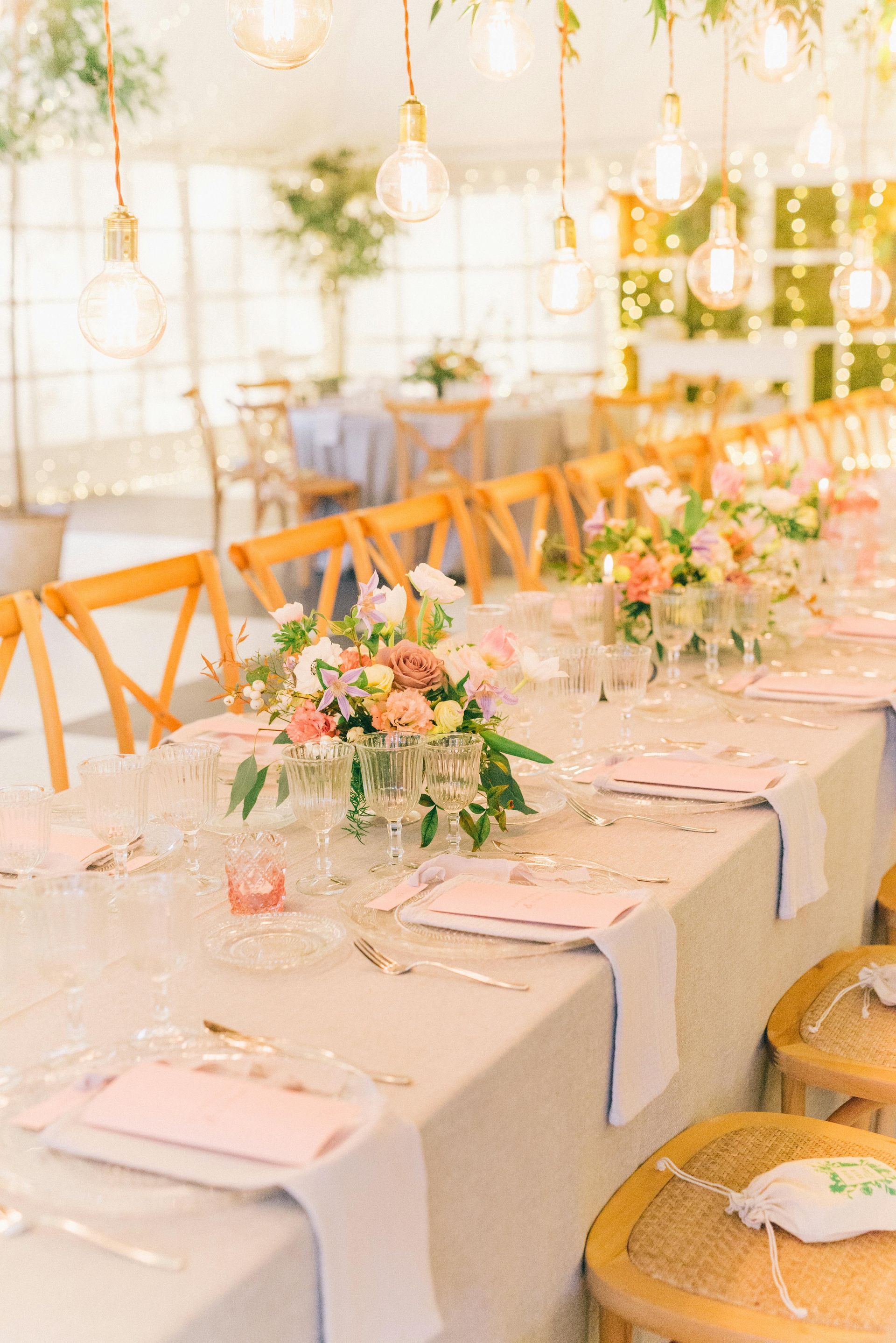 Wedding reception table setup with flowers and chairs at The R.F. Strickland Co. venue.