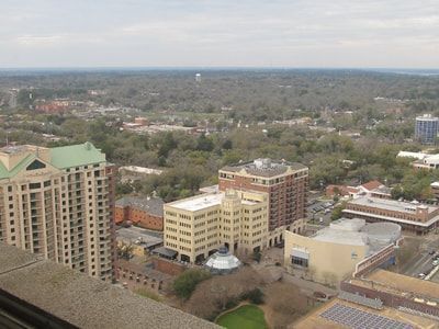An aerial view of a city with lots of buildings and trees