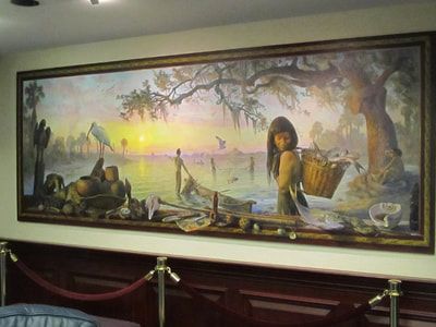 A large painting of a woman carrying a basket is hanging on a wall