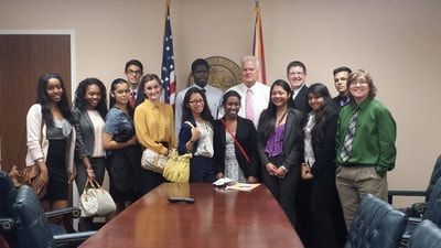 A group of people are posing for a picture in a conference room.