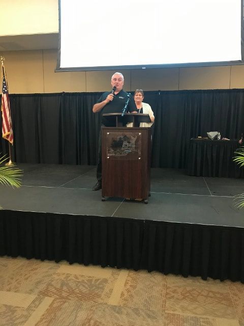 A man is standing at a podium giving a speech
