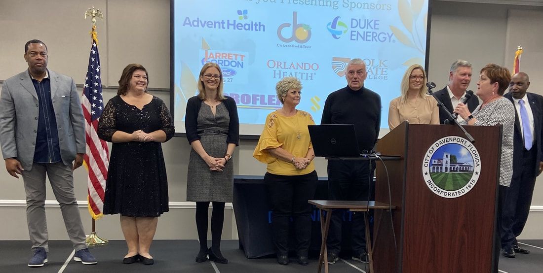 A group of people are standing in front of a podium.