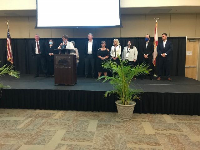 A group of people standing on a stage in front of a podium