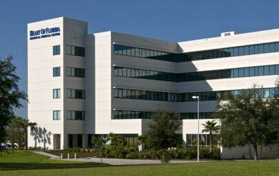 A large white building with a blue logo on the side of it