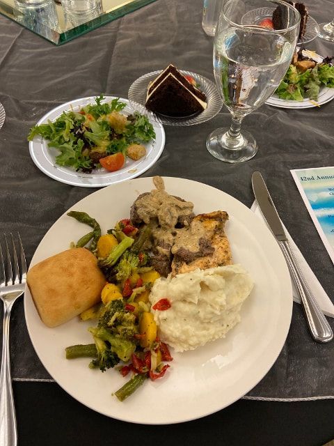 A plate of food with mashed potatoes and vegetables on a table