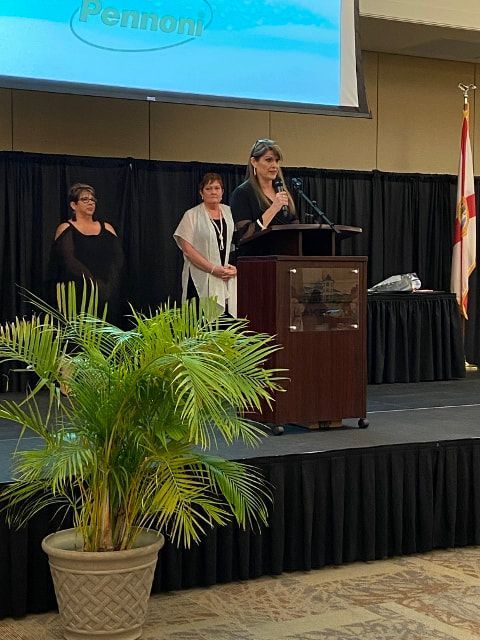 A woman is standing at a podium giving a speech.