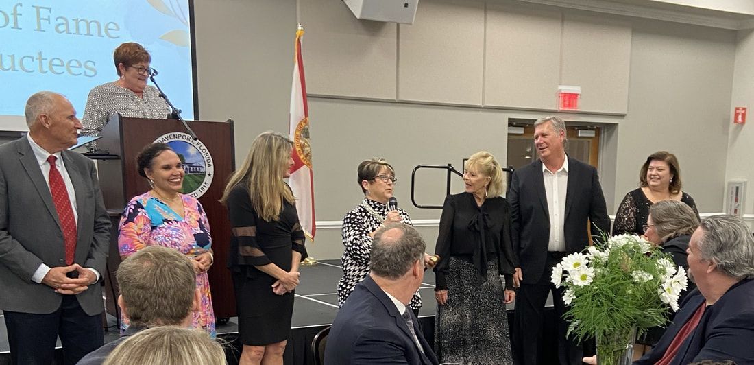 A group of people are standing around a podium in a room.