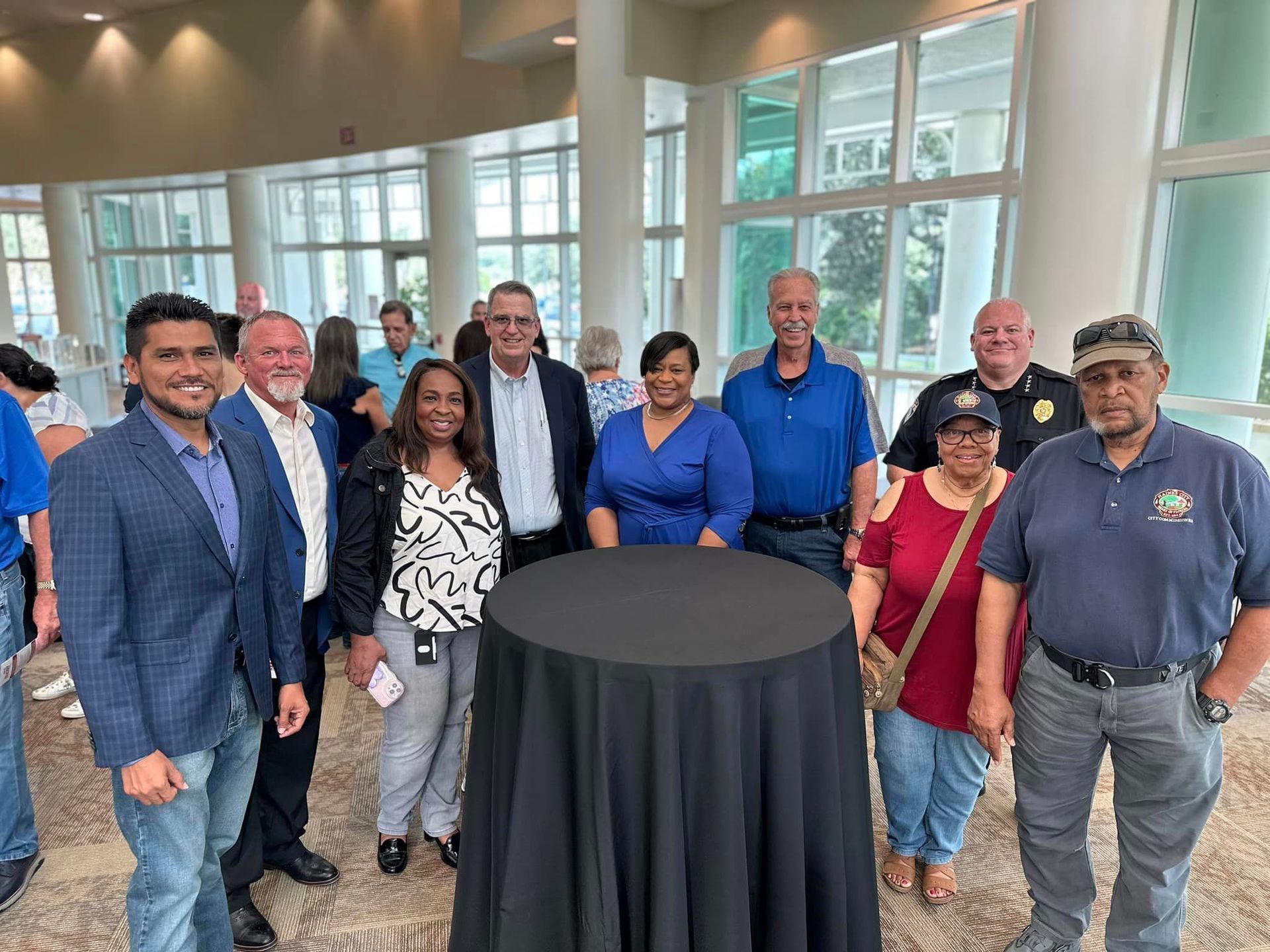 A group of people are posing for a picture in front of a table.