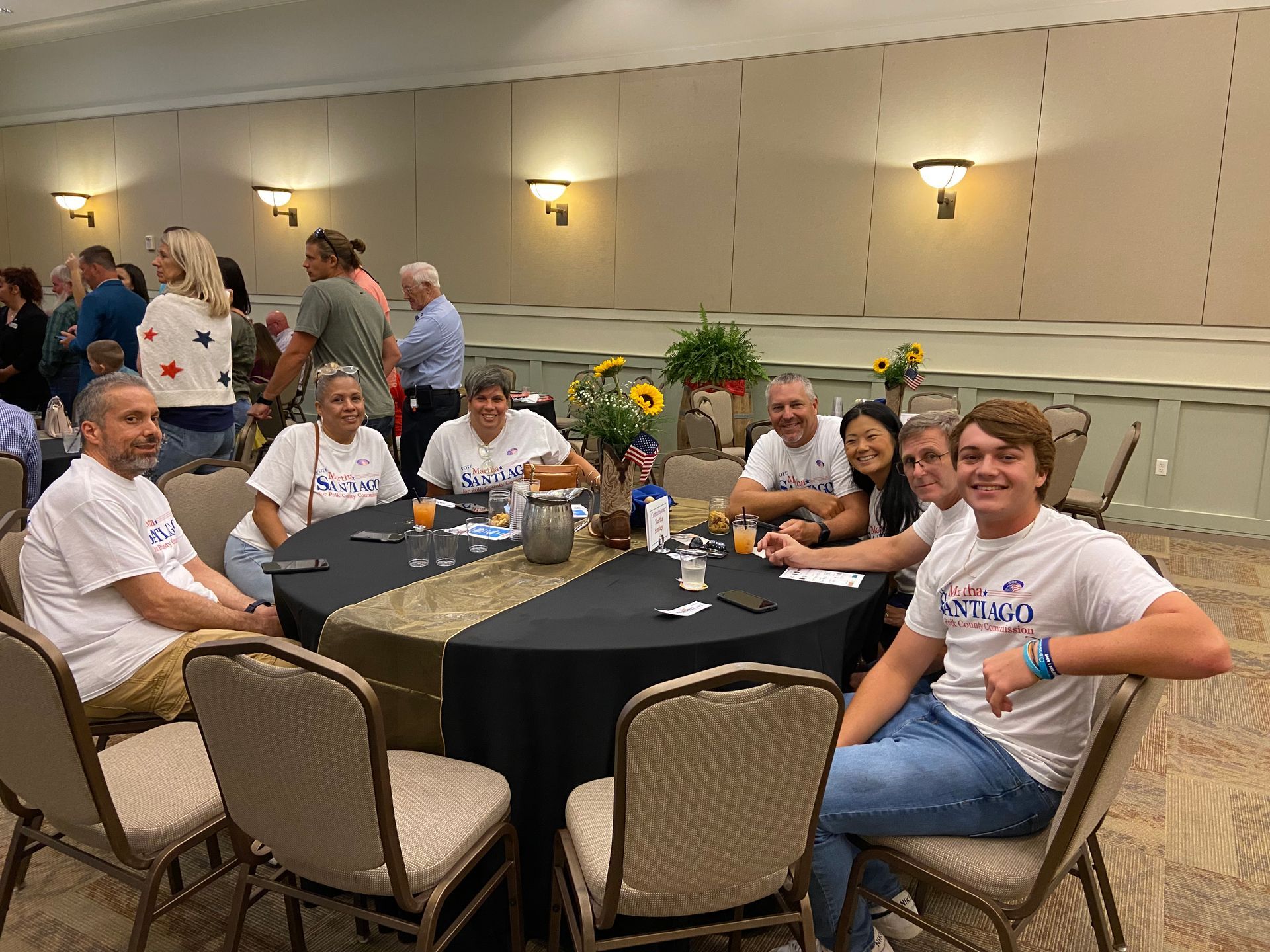 A group of people are sitting around a table in a room.