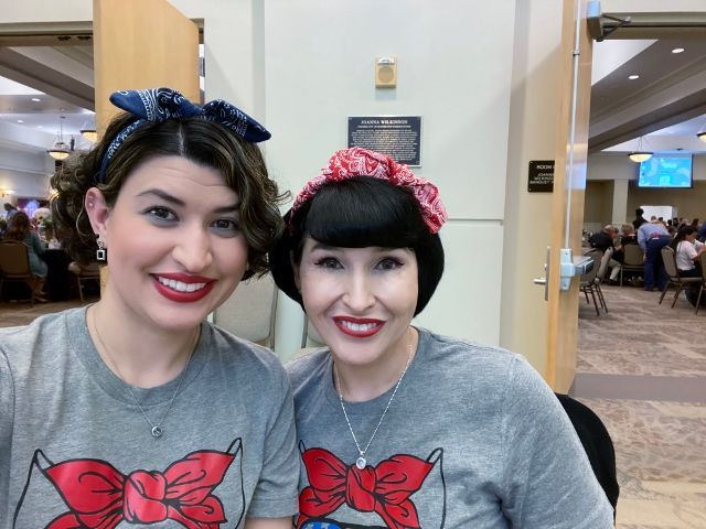 Two women are posing for a picture and one has a bandana on her head