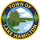 The seal of the town of lake hamilton shows a tree and a river.