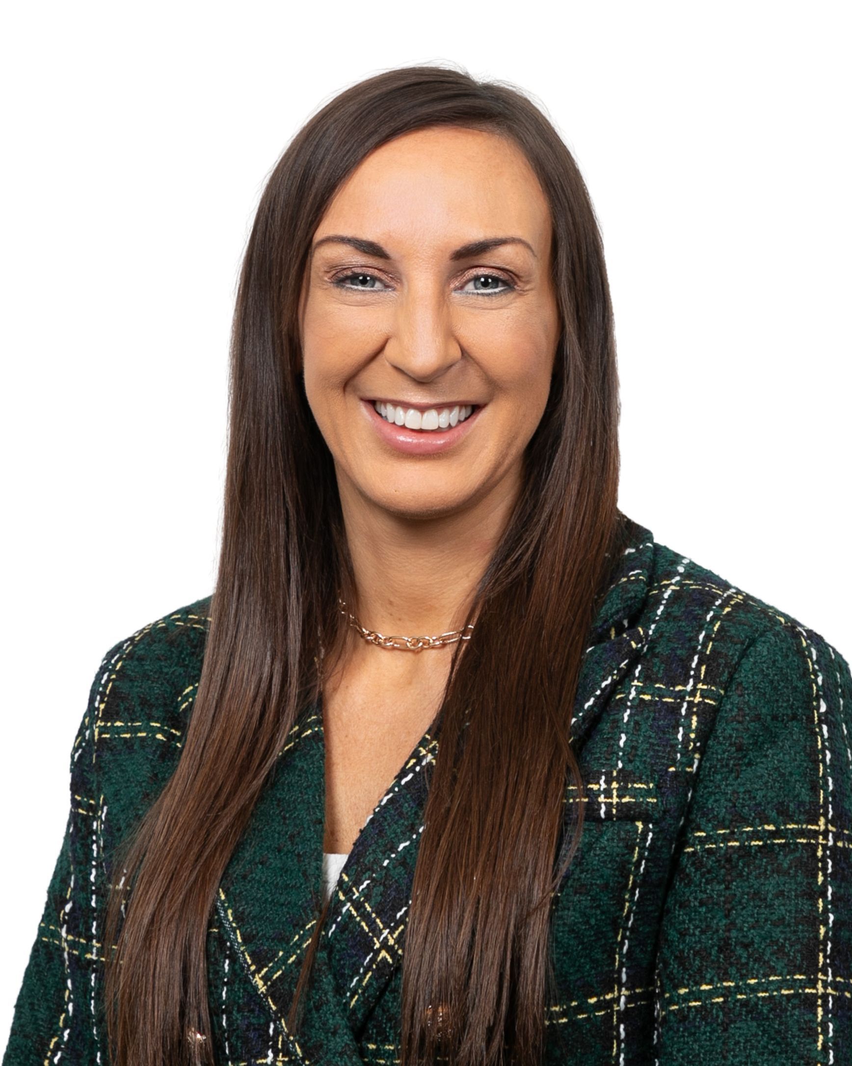 Portrait of a smiling woman in a green plaid blazer against a white background