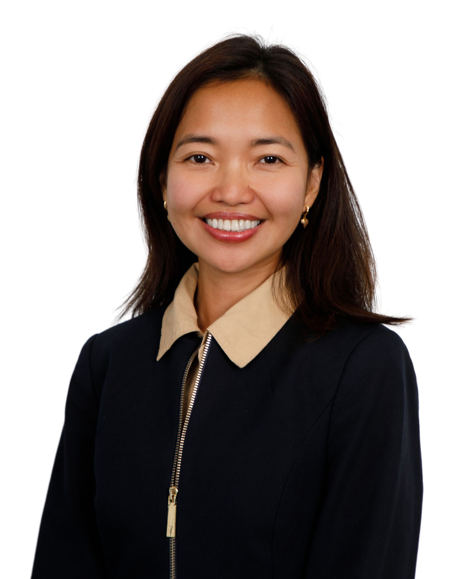 Smiling person in a black blazer with beige collar against a white background