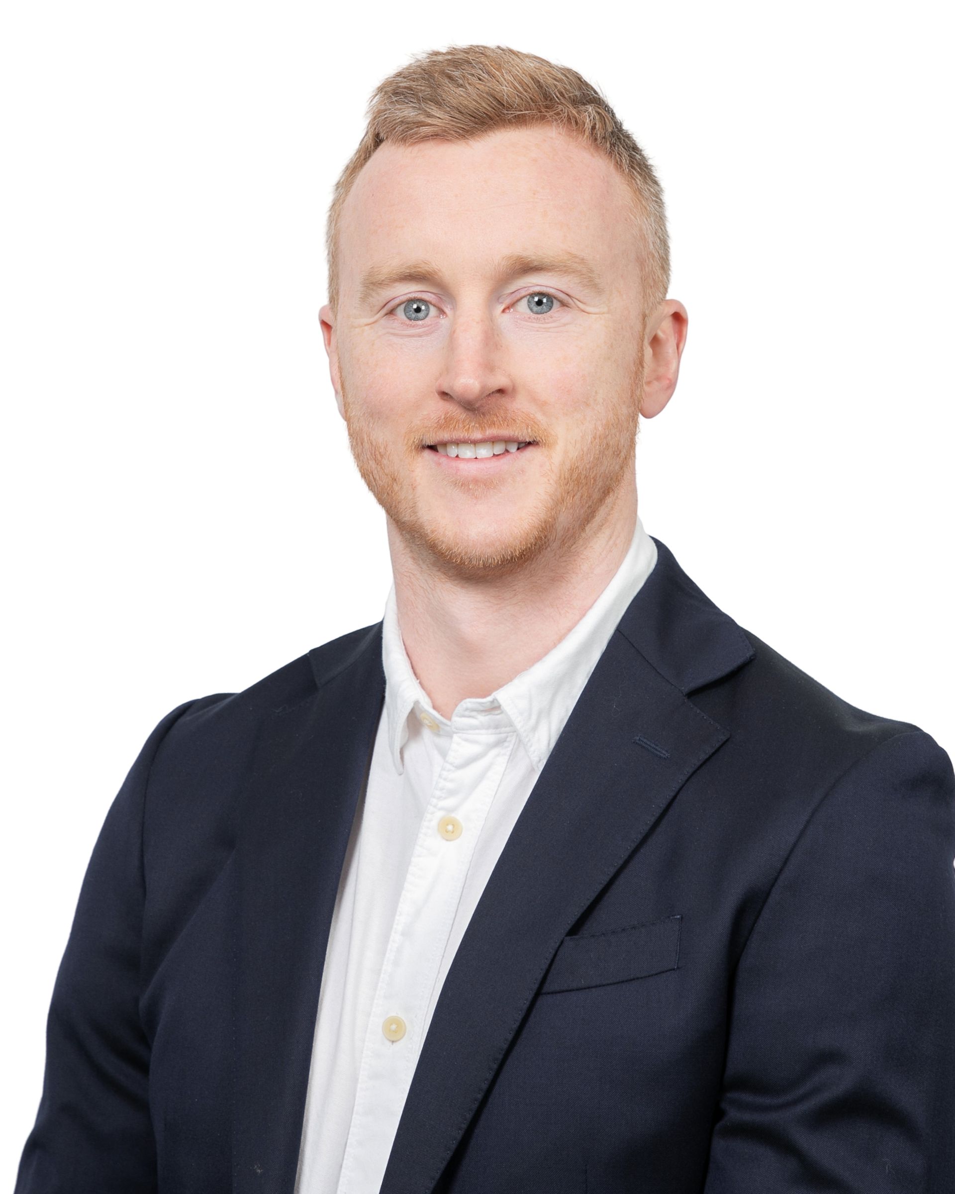 Portrait of a man in a navy blazer and white shirt against a white background