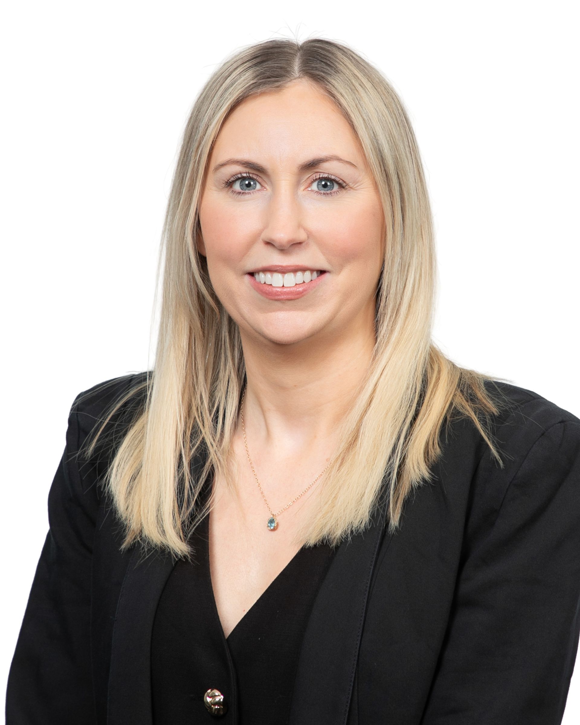 Portrait of a smiling person in a black blazer against a white background