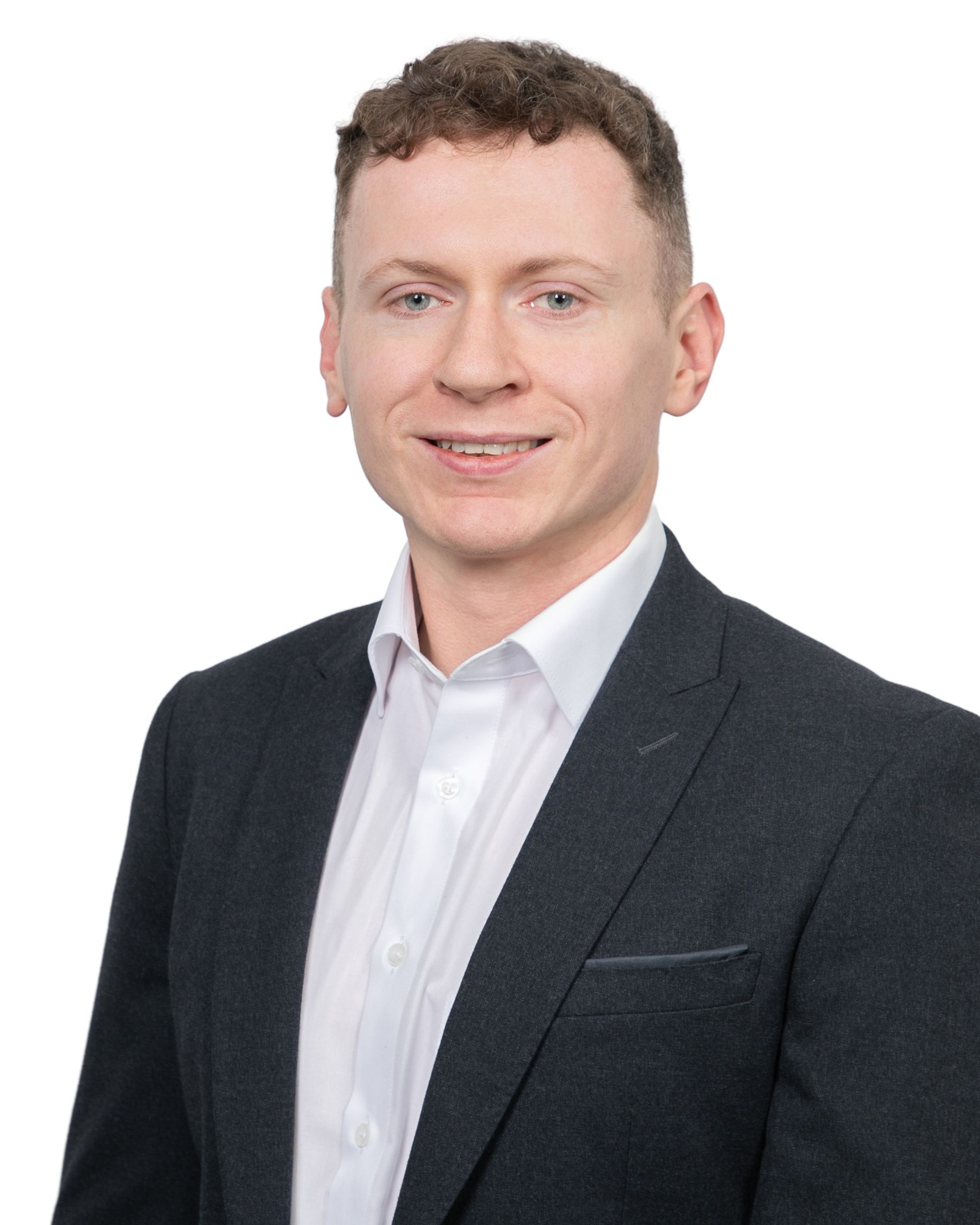 Studio portrait of a person in a dark blazer and white shirt on a white background