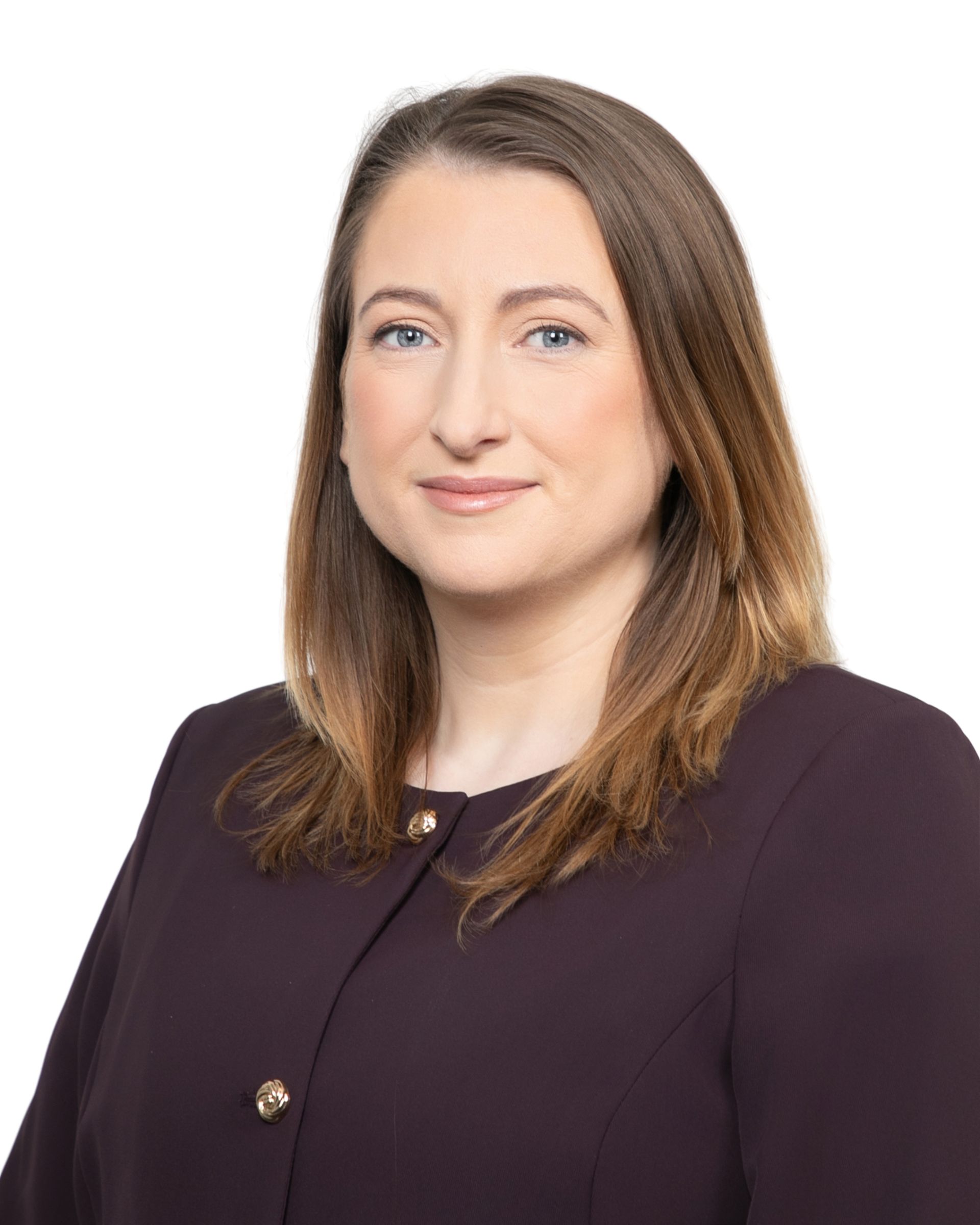 Studio headshot of a person in a dark purple blazer against a white background