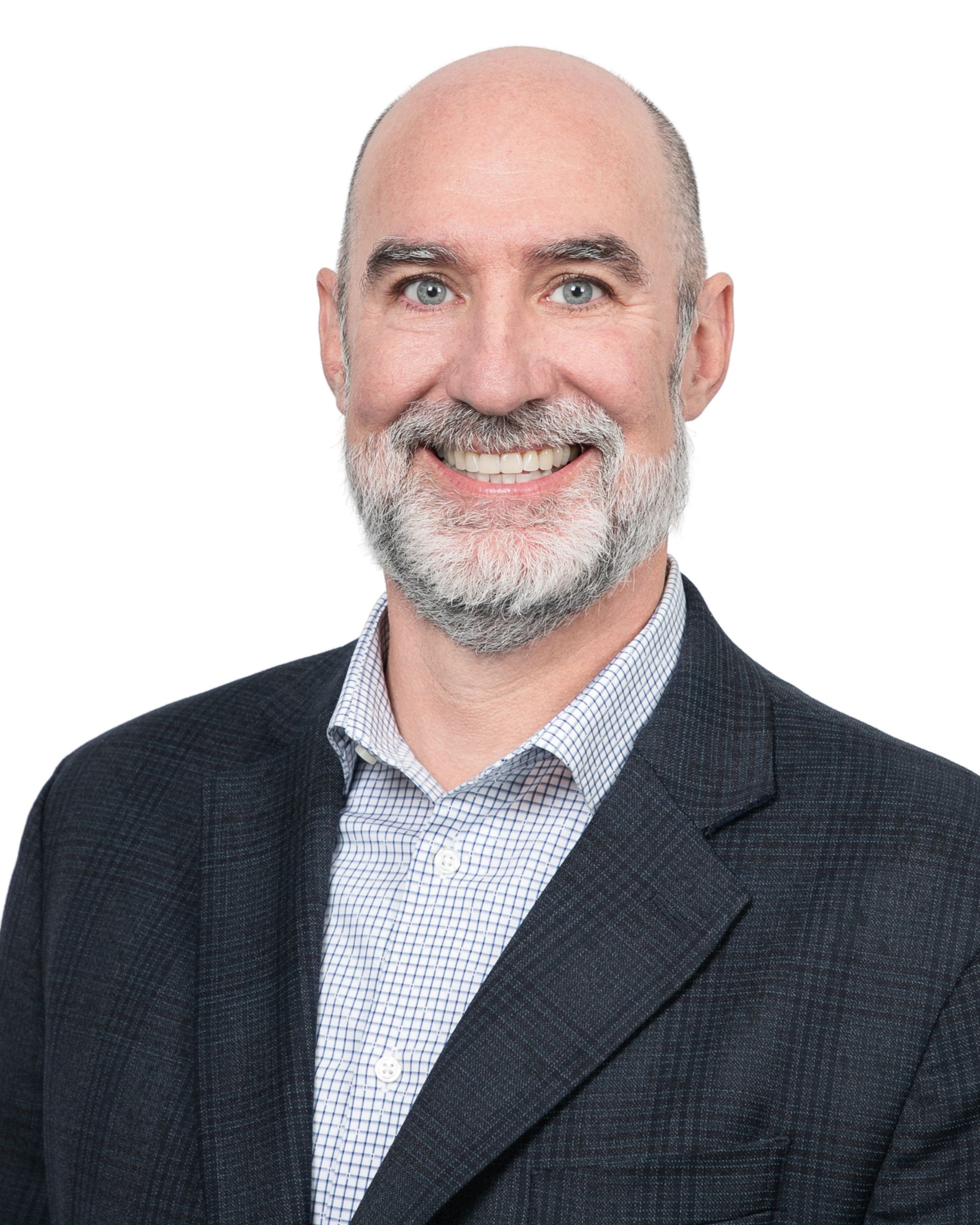 Headshot of a smiling bald man with a gray beard in a dark blazer and patterned shirt on a white background