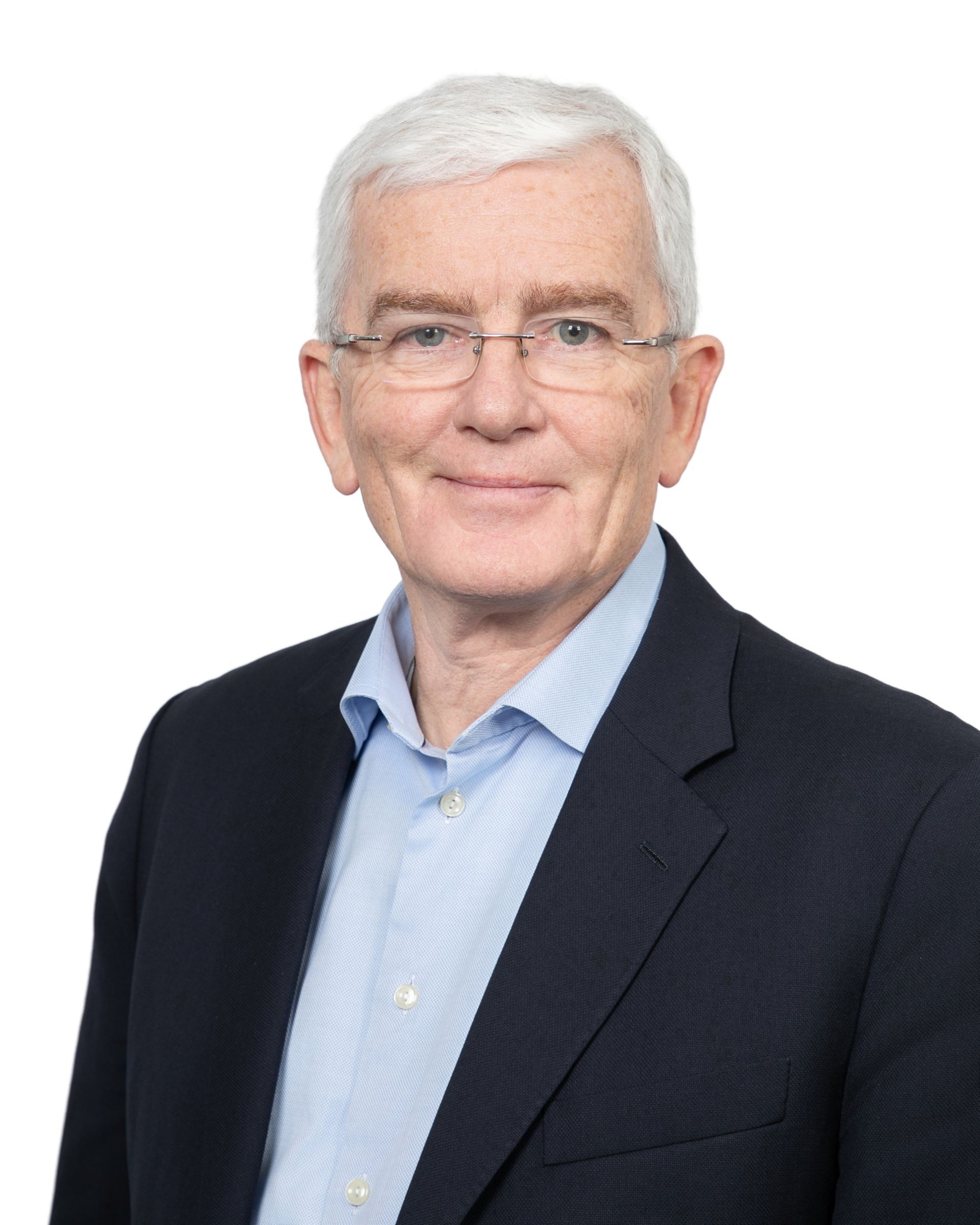 Portrait of a man in a dark suit and light blue shirt on a white background