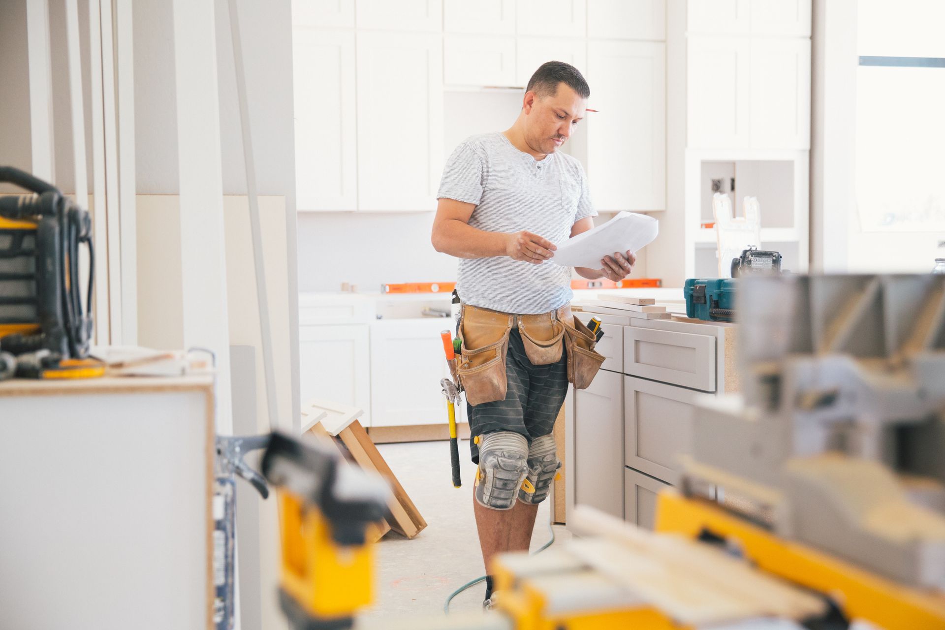 A contractor working on residential kitchen renovation services.