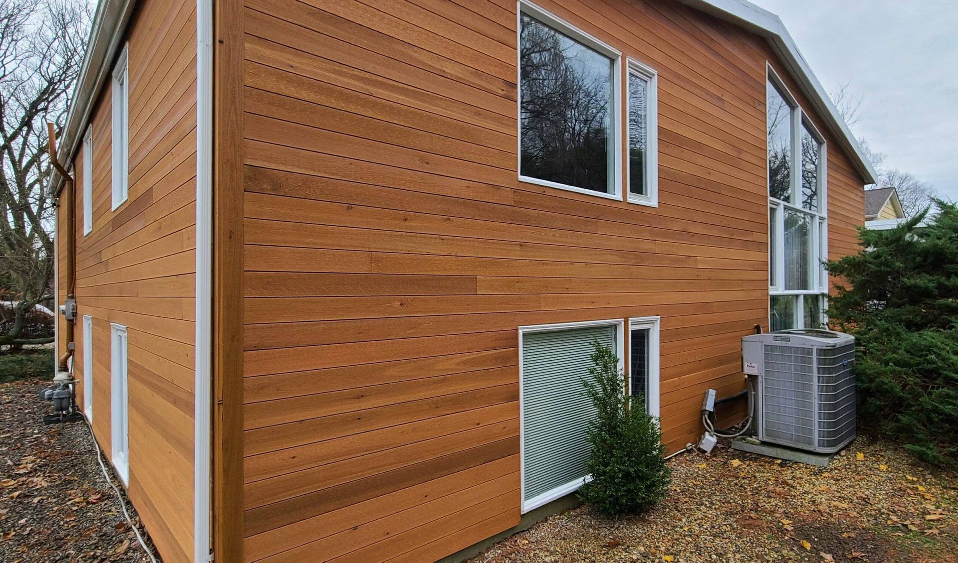 A large wooden house with a lot of windows.