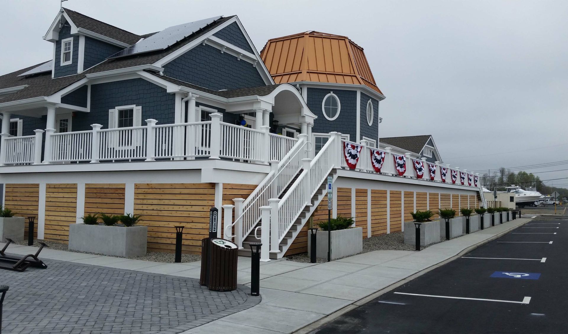 A large blue and white house with stairs leading up to it.