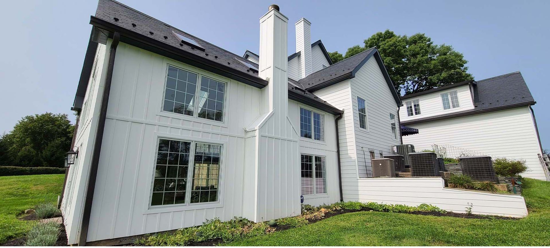 A blue house with white trim and shutters on the windows.