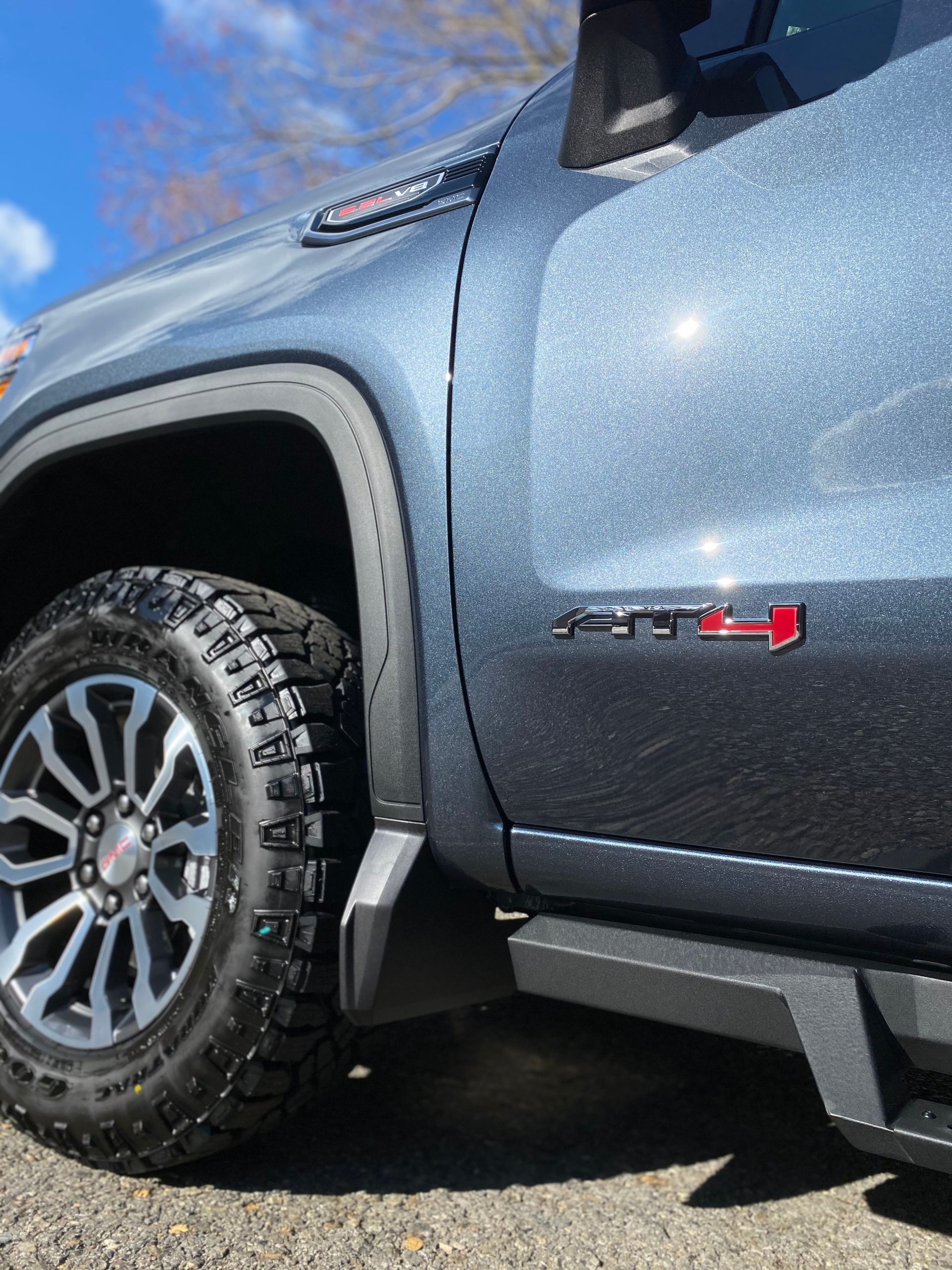 A close up of a gmc truck parked on the side of the road.