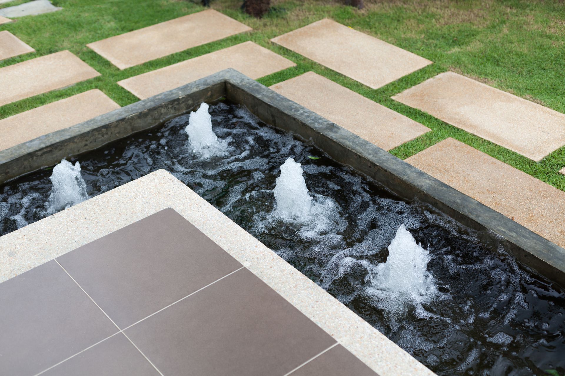 There is a fountain in the middle of the garden.