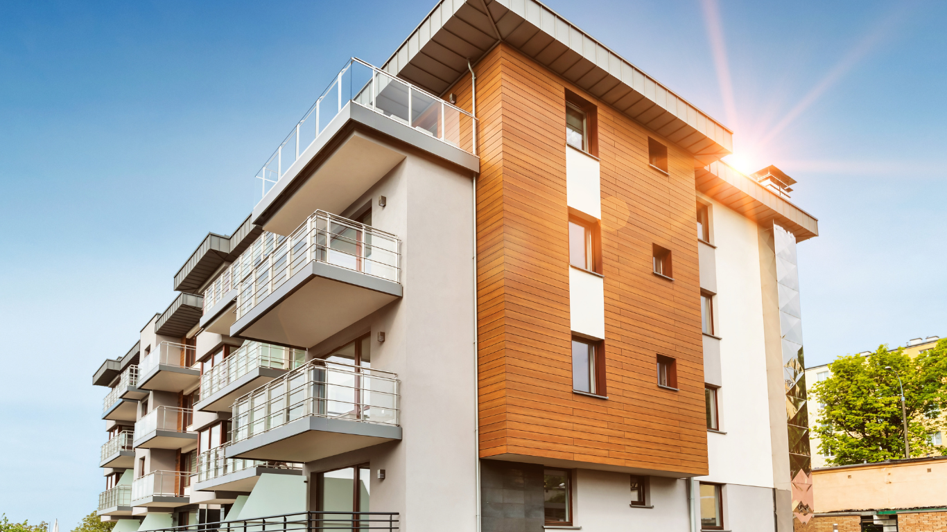 A large apartment building with the sun shining through the windows.