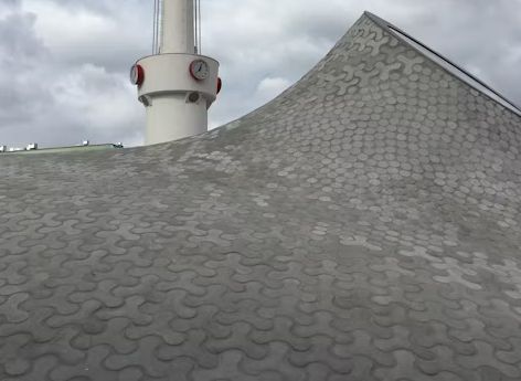 The roof of a building with a clock tower on top of it.
