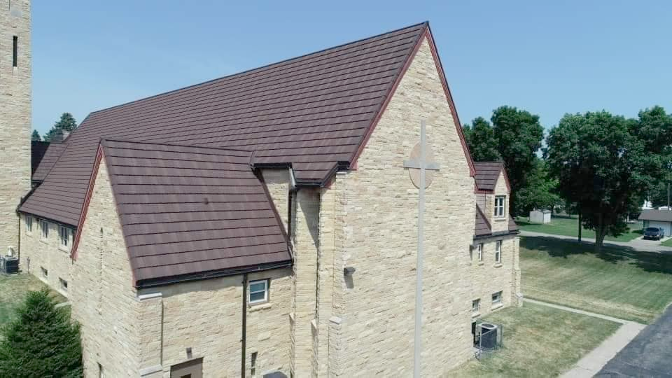 An aerial view of a church with a brown roof.