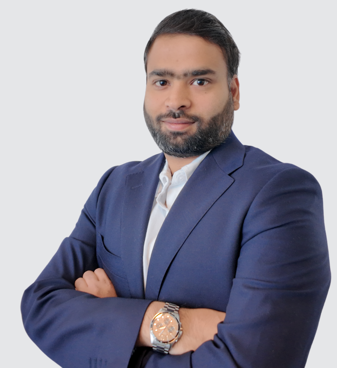 A man in a suit with his arms crossed and a watch on his wrist