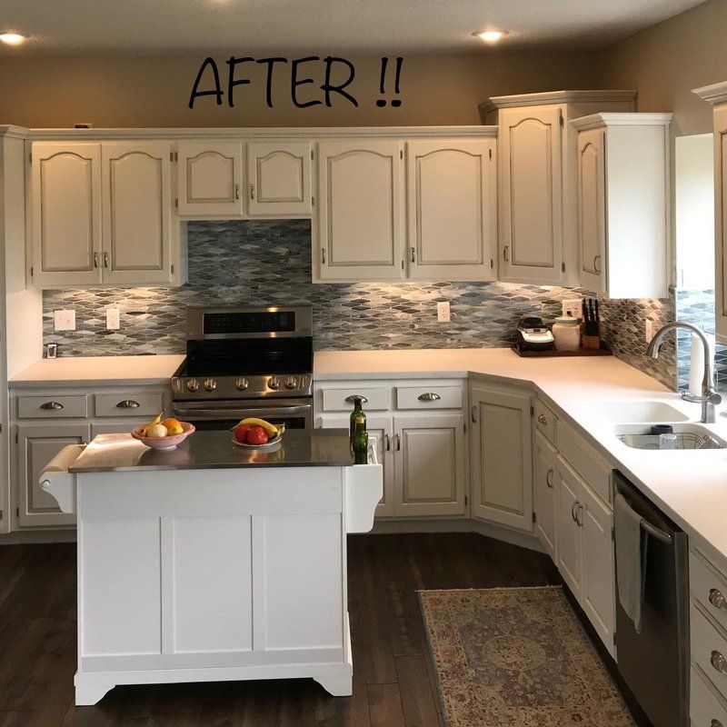 White kitchen remodel with distressed cabinets, island, and blue tile backsplash.