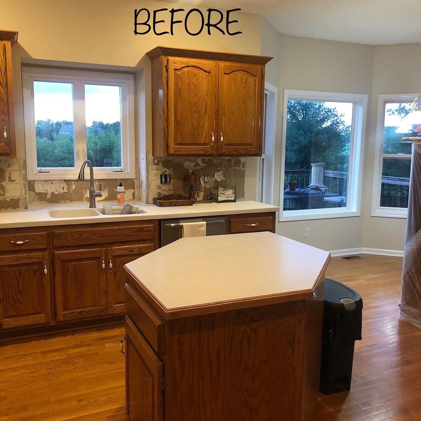 Kitchen with wooden cabinets, island, and windows, labeled 