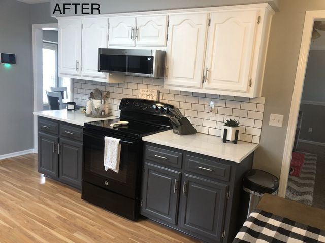 Kitchen with two-tone cabinets: white upper, dark gray lower, subway tile backsplash, and black appliances.