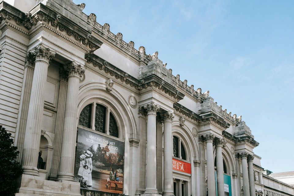 A large building with columns and a sign on the side of it.