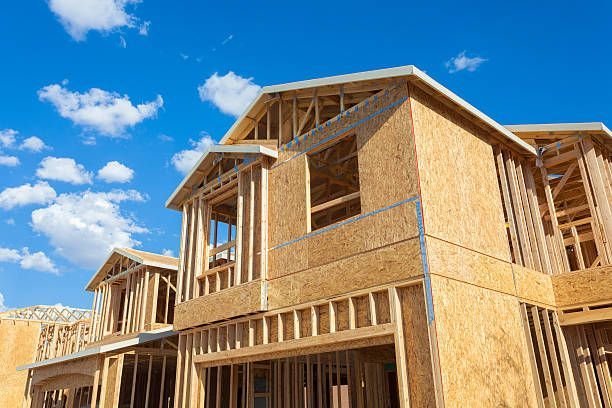 A house is being built with a blue sky in the background.