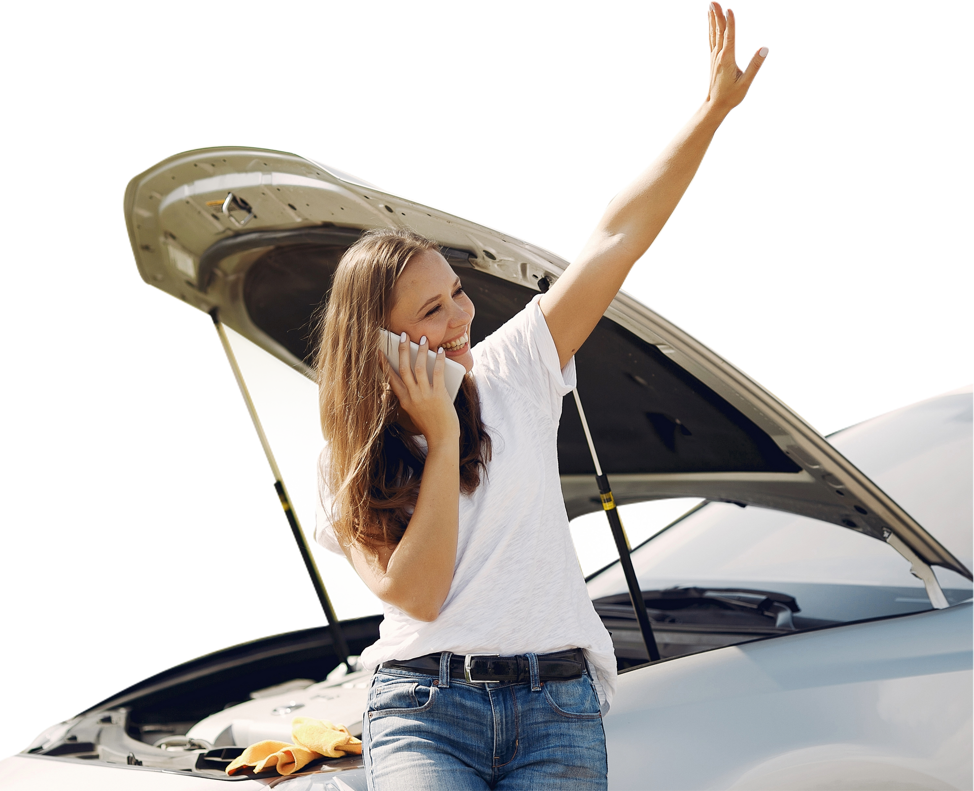 A woman is talking on a cell phone next to a broken down car.