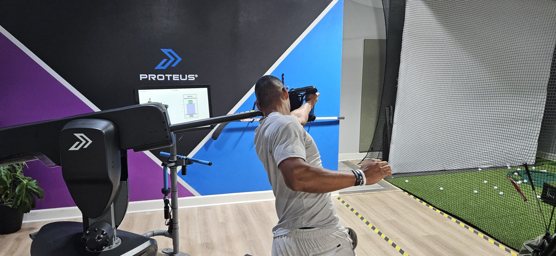 A man is standing in front of a camera in a room.