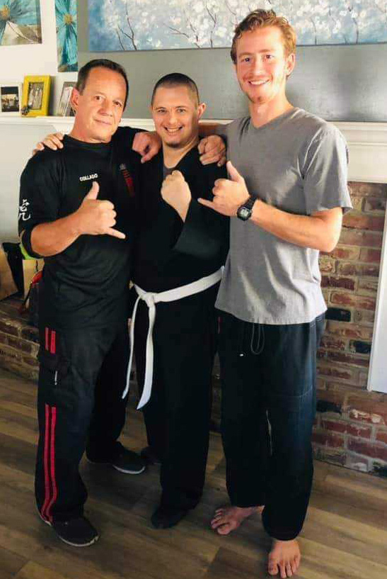Three men are posing for a picture together in a living room.
